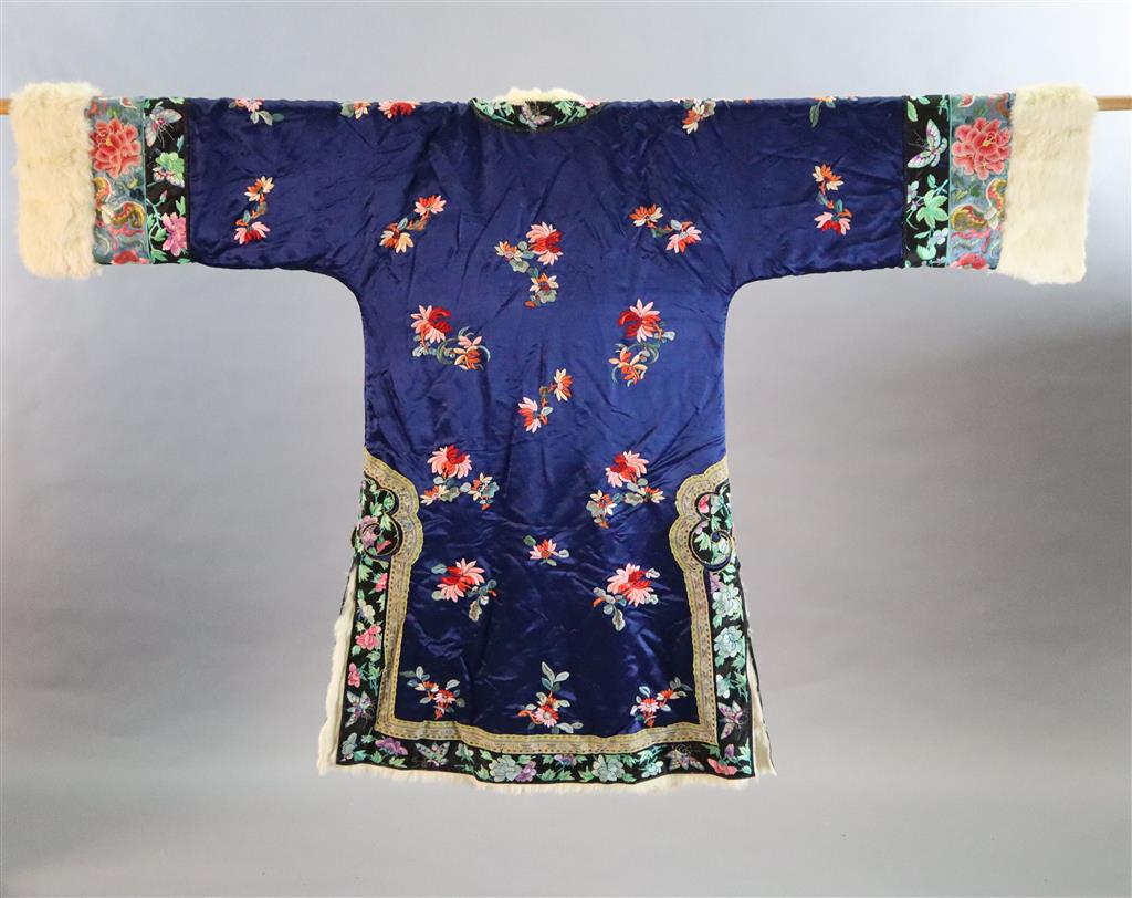 A Chinese blue silk multicoloured embroidered Chinese winter robe, early 20th century, with a white fur lining, length 108cm